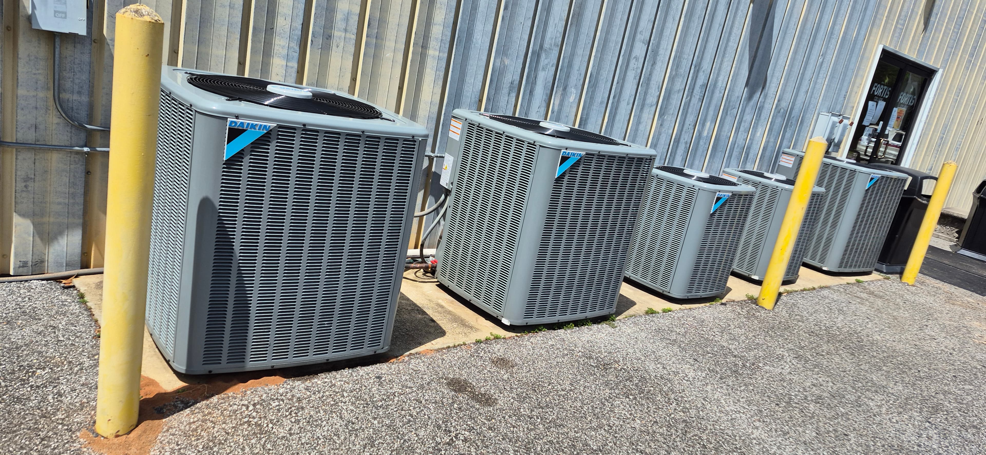 Row of newly installed air conditioning condensing units by ProPoint HVAC in Mobile, Alabama
