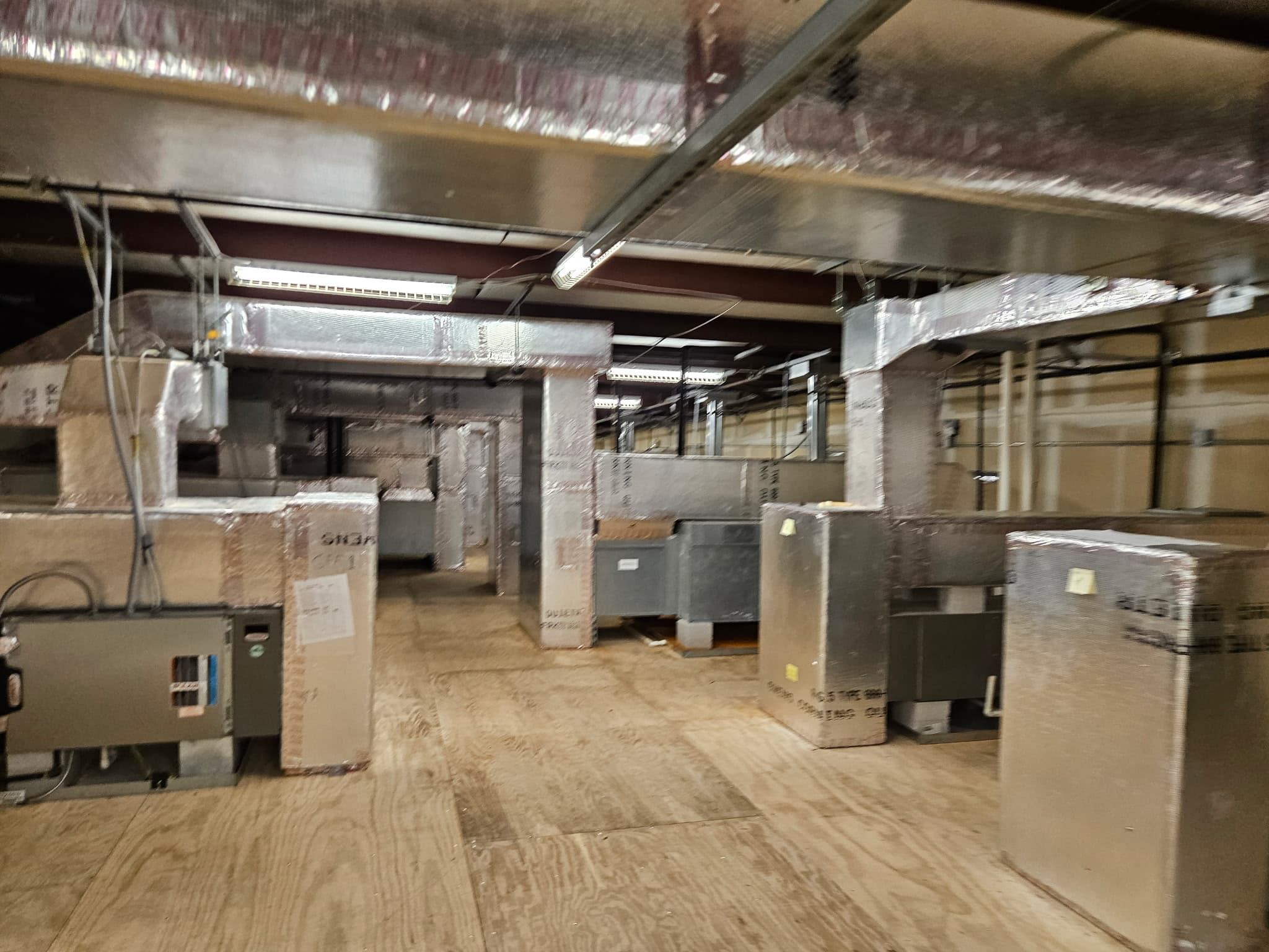 Large commercial HVAC installation with multiple units and insulated ductwork